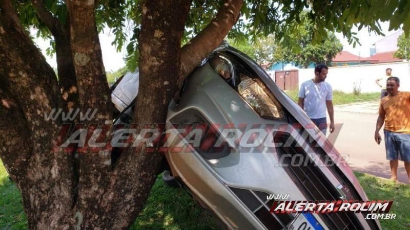 Carro fica suspenso em árvore após colisão em Rolim de Moura